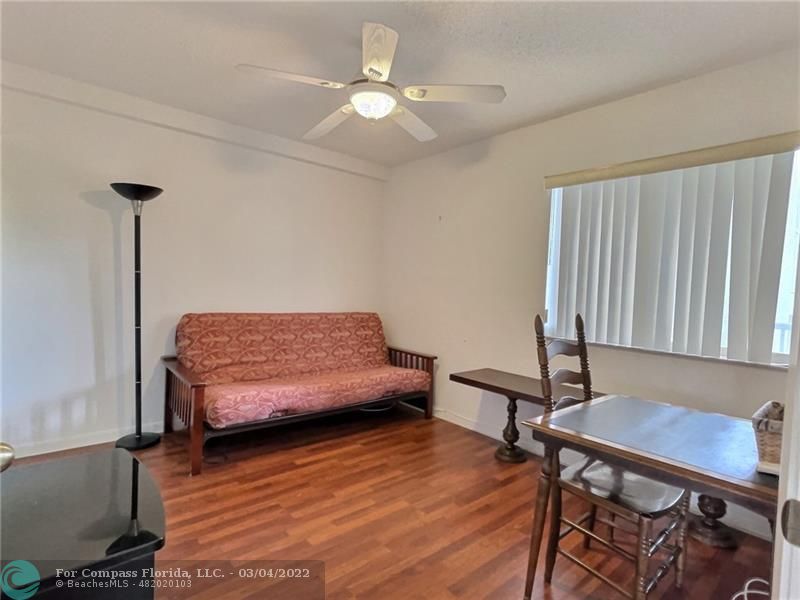 9537 Weldon Circle, Unit I308 Tamarac, FL 33321 - Photo 7 of 12 a bedroom with furniture and a wooden floor