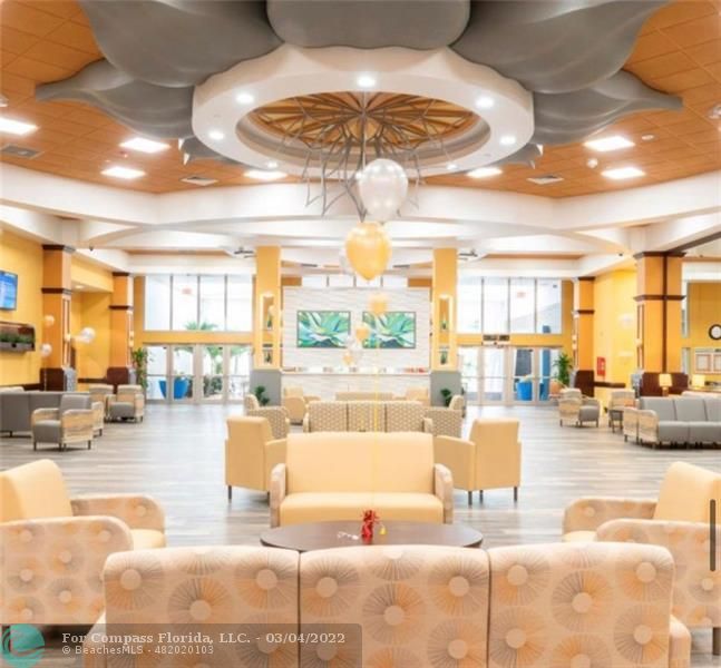 9537 Weldon Circle, Unit I308 Tamarac, FL 33321 - Photo 9 of 12 a living room with fireplace furniture and a large window