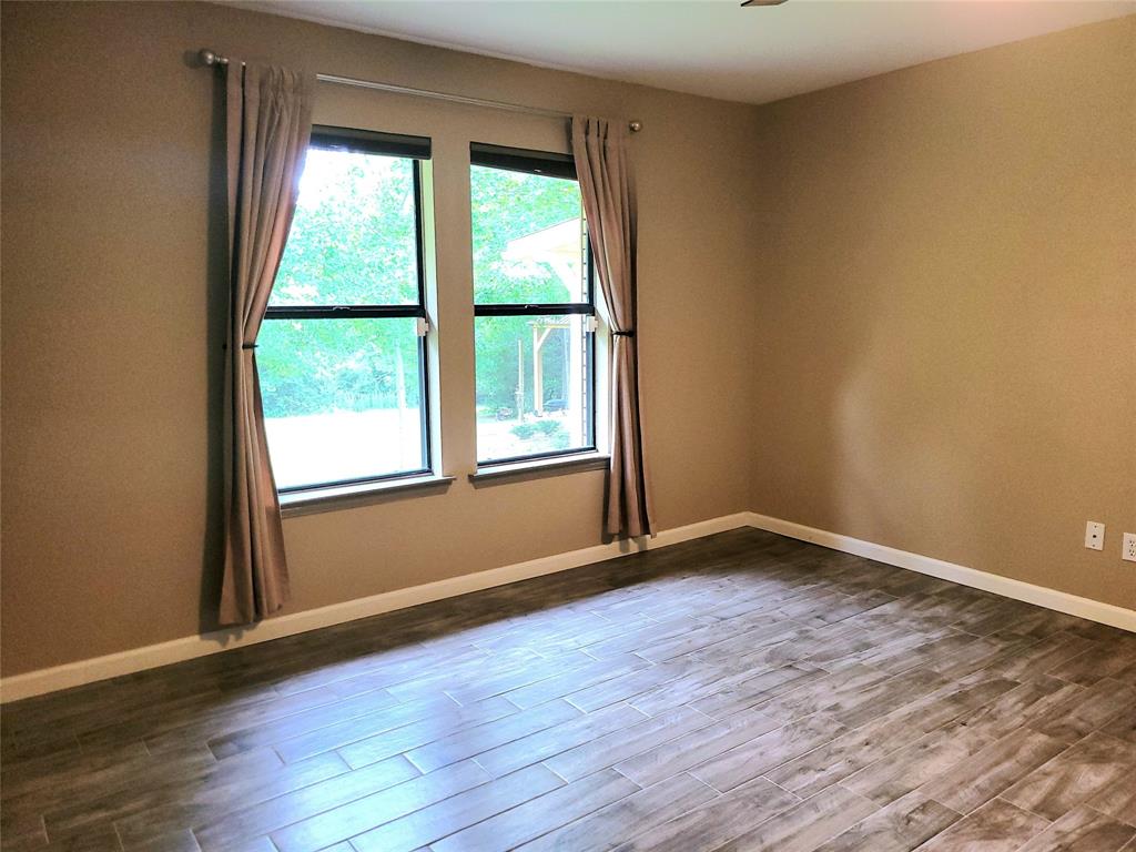 912 North Dove Road Grapevine, TX 76051 - Photo 19 of 36 a view of an empty room with wooden floor and a window