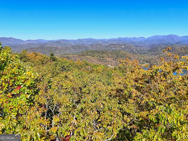 a view of a large mountain with a mountain in the background