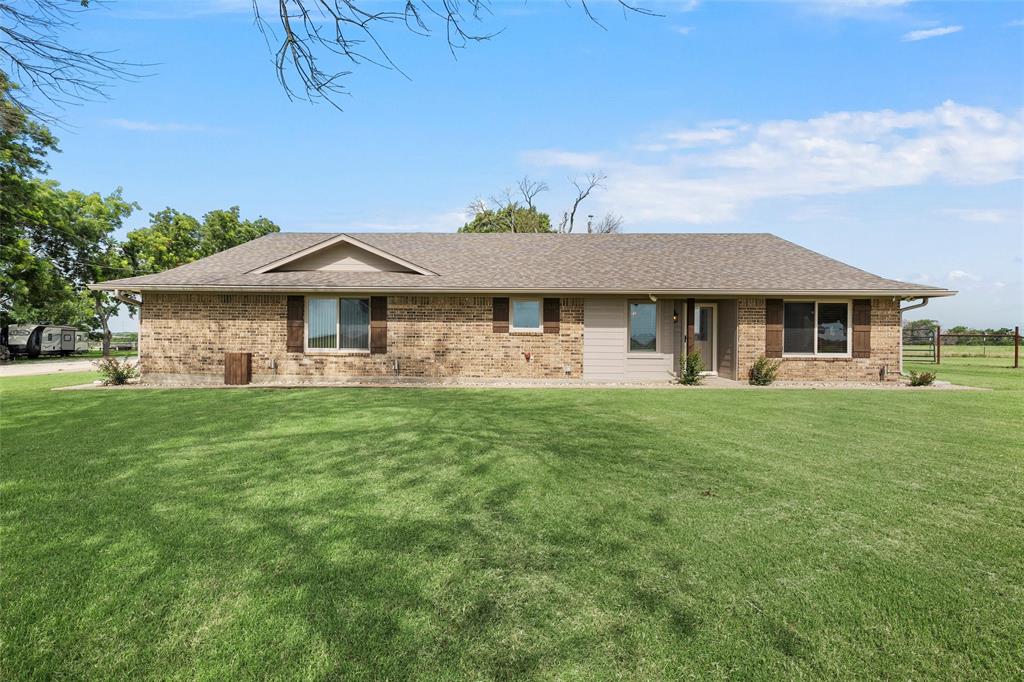11541 Old Dallas Road West, TX 76691 - Photo 1 of 39 a front view of a house with a garden