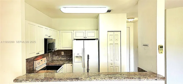 a view of a bathroom with a tub shower and mirror