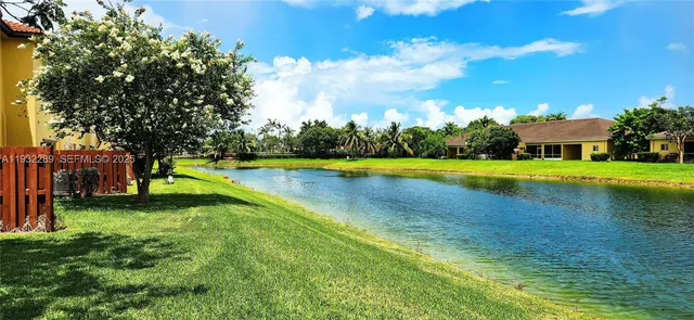 a view of a swimming pool with lawn chairs and a big yard