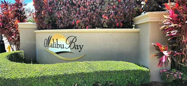 a backyard of a house with lots of green space and a fountain