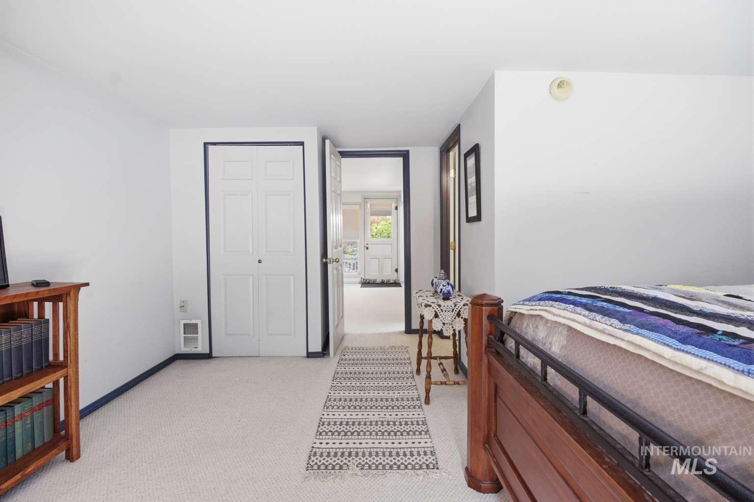 901 Main Street Kendrick, ID 83537 - Photo 32 of 50 Carpeted room featuring white walls, dark trim, and a bi-fold closet door