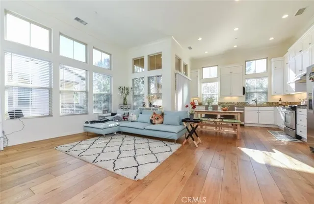 a living room with furniture fireplace and wooden floor