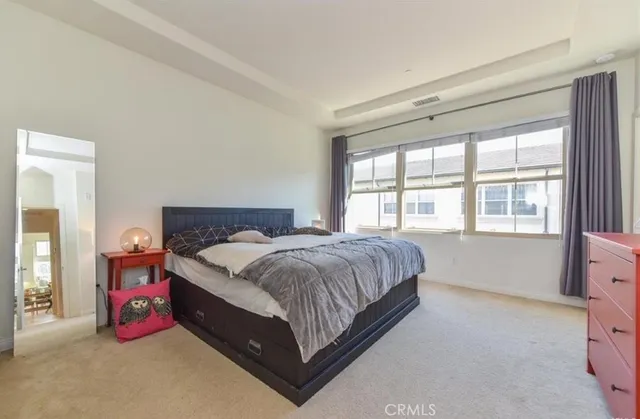 a spacious bedroom with a bed and window