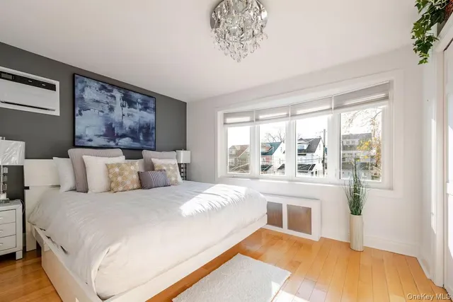 a bedroom with a large bed and a chandelier