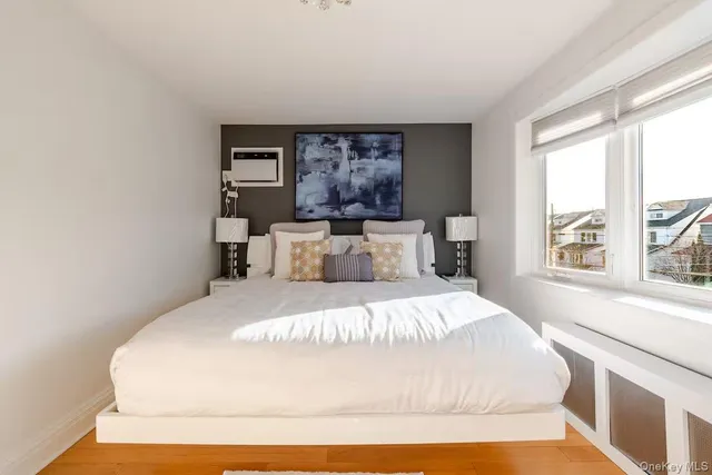 a bedroom with a large bed and a window