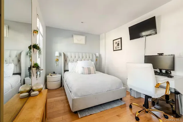 a bedroom with a bed tv and table