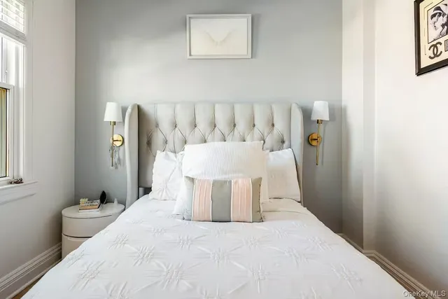 a bed room with a bed and a chair