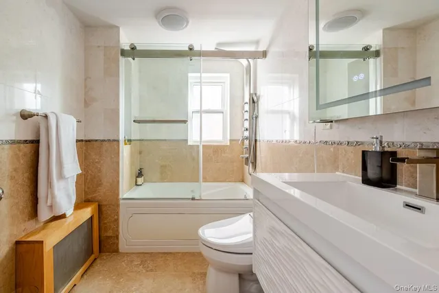 a bathroom with a sink a toilet and bathtub