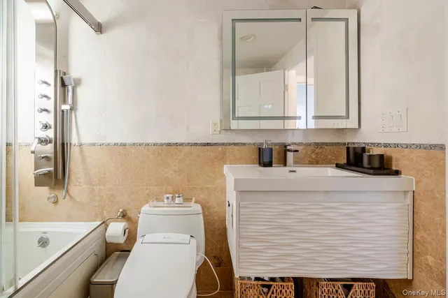 a bathroom with a sink a toilet and a bathtub