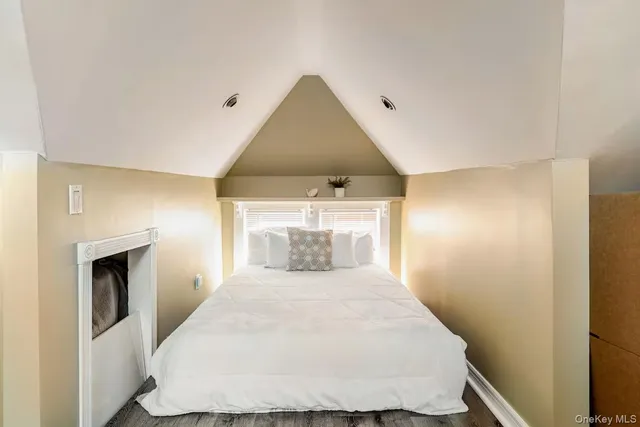 a spacious bedroom with a bed and a window