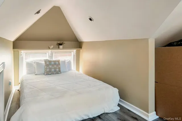a large white bed in a small room