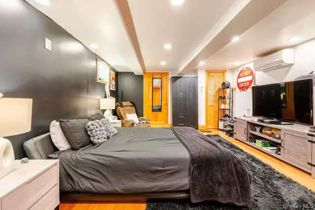 a bedroom with a bed and a flat screen tv