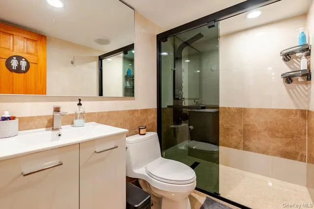 a bathroom with a sink toilet and shower