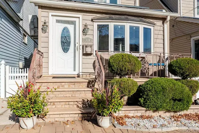 a front view of a house with garden