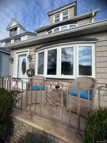 a front view of a house with large windows