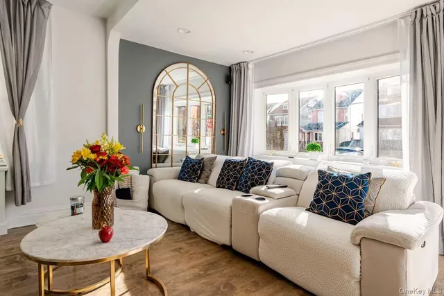 a living room with furniture and a potted plant