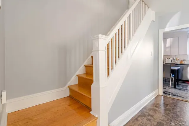 a view of entryway and hall with wooden floor