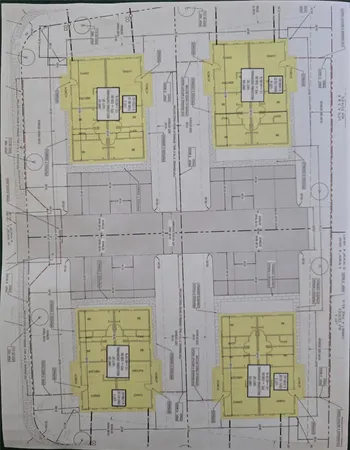 an aerial view of residential houses with city view