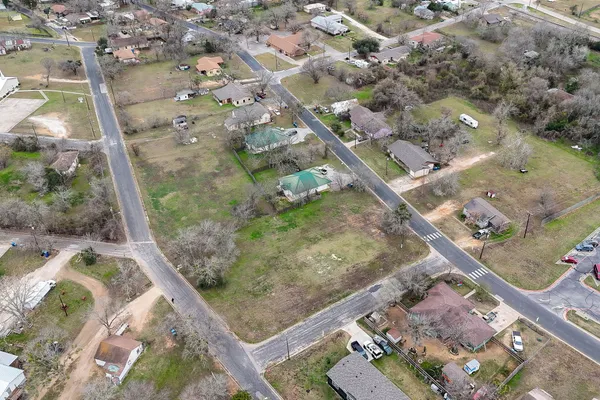 an aerial view of a residential houses with outdoor space