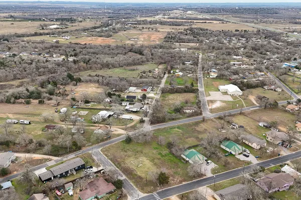 an aerial view of residential houses with yard