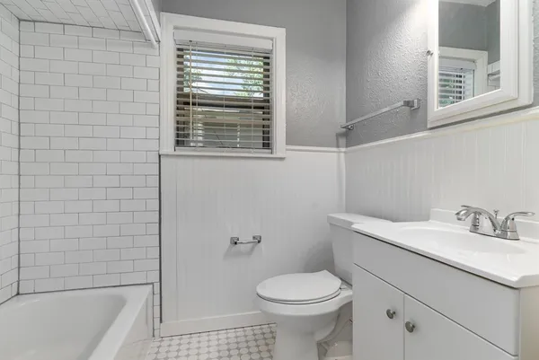 a bathroom with a sink a toilet and bathtub