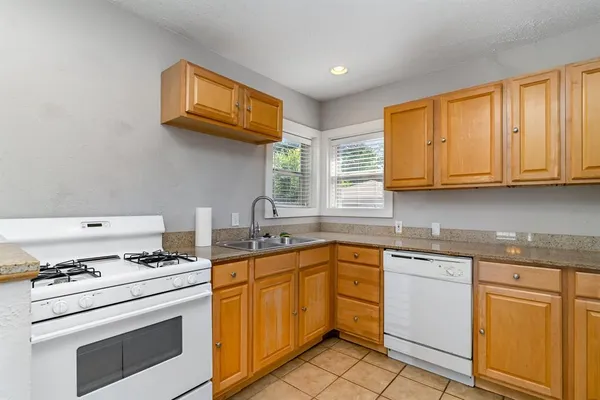 a kitchen with stainless steel appliances granite countertop a stove and a sink