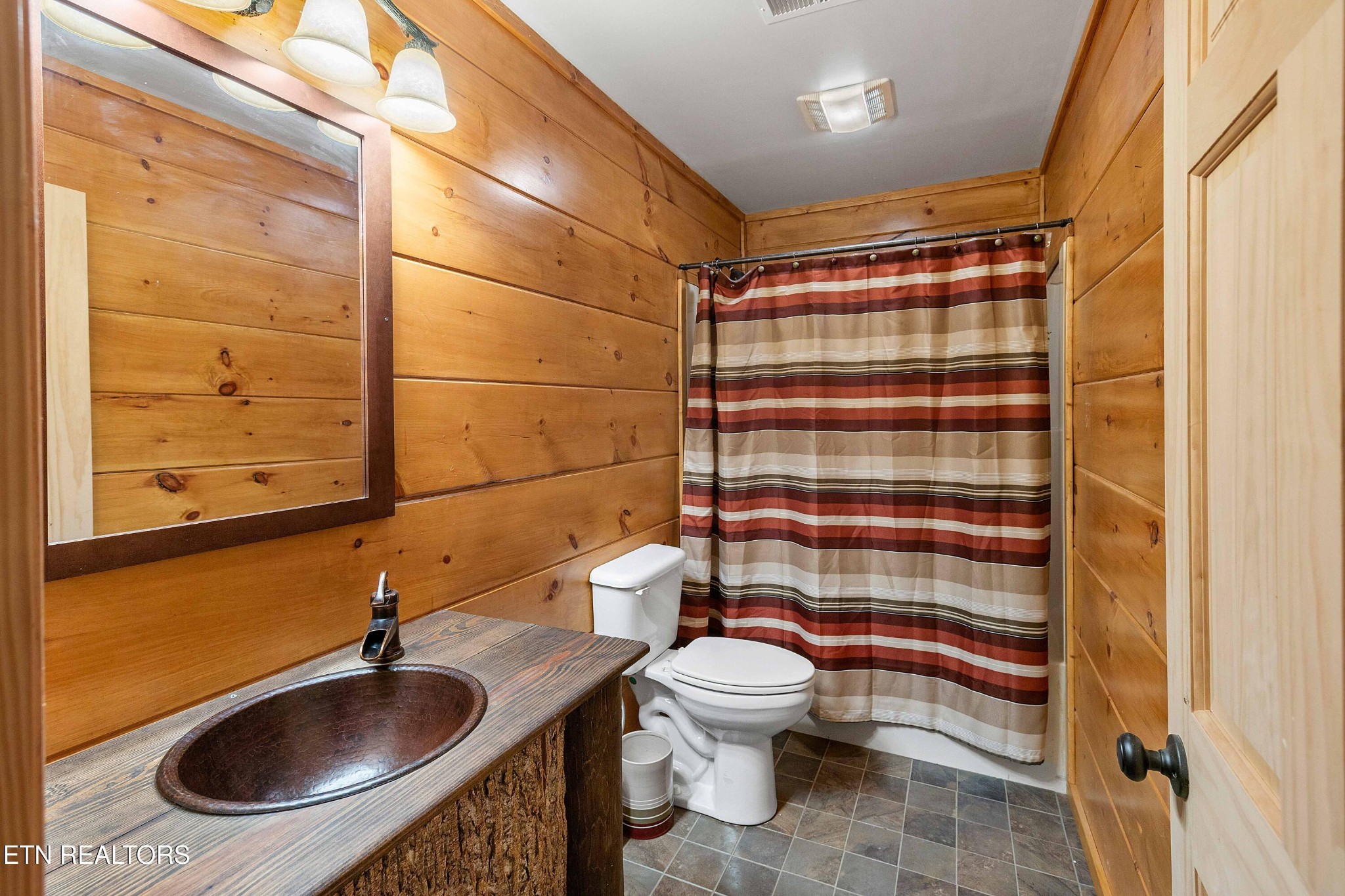 11911 Stockton Valley Road Philadelphia, TN 37846 - Photo 54 of 56 a bathroom with a sink a toilet and shower curtain