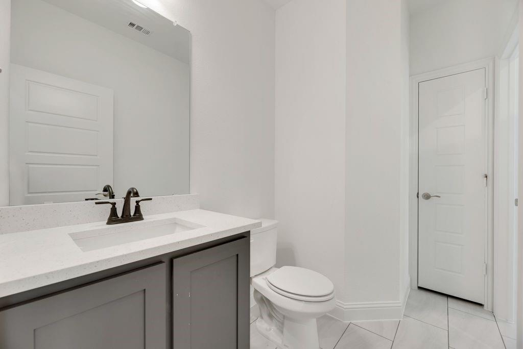 128 Loveta Lane Boyd, TX 76023 - Photo 11 of 15 a bathroom with a sink a toilet and mirror