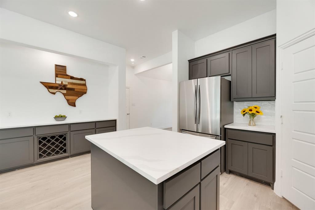 128 Loveta Lane Boyd, TX 76023 - Photo 4 of 15 a kitchen with a refrigerator and a stove top oven