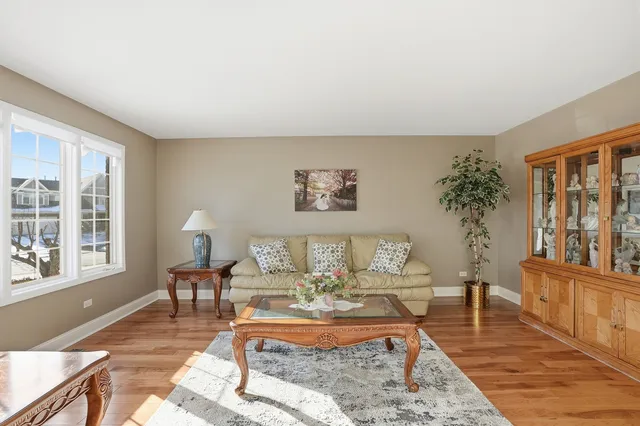a living room with furniture a table and a large window
