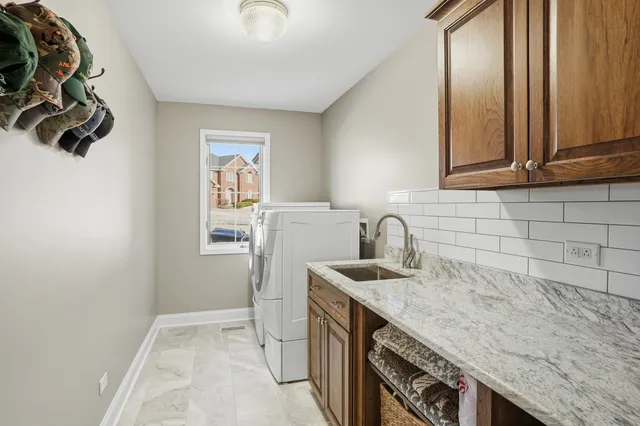 a kitchen with a sink a stove and cabinets