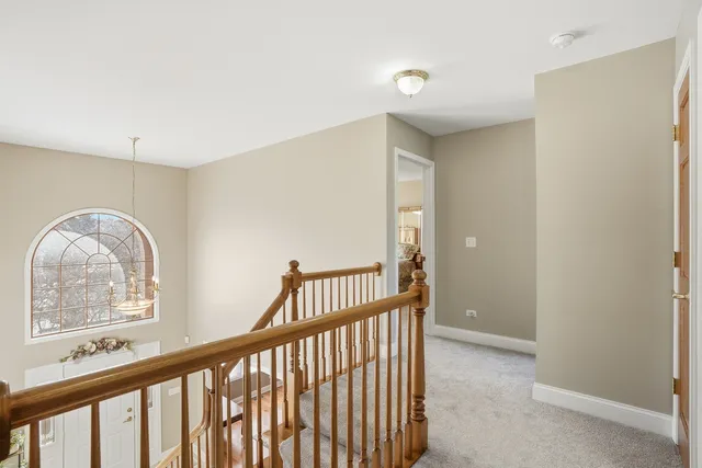 a view of staircase with a floor to ceiling window and a projector room