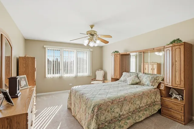 a bedroom with a bed flat screen tv and a large window