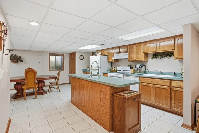 a kitchen with stainless steel appliances granite countertop sink microwave and window