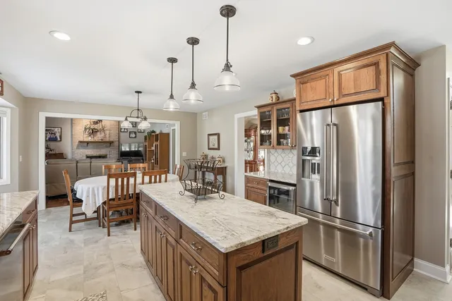 a kitchen with kitchen island a counter top space appliances and cabinets