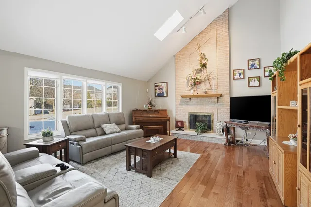 a living room with furniture a fireplace and a flat screen tv