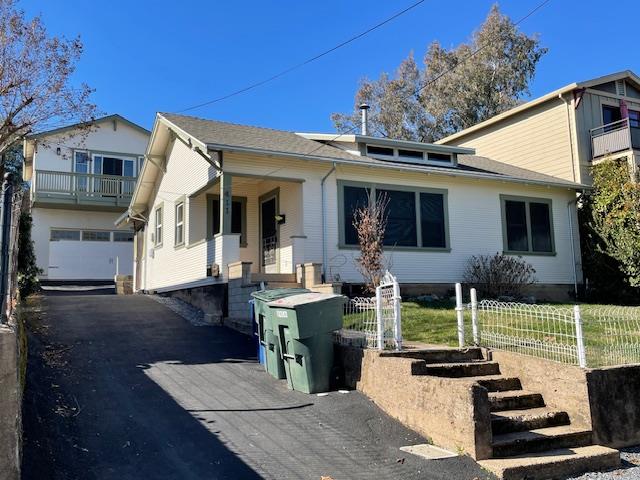a view of house with patio outdoor seating and covered with trees