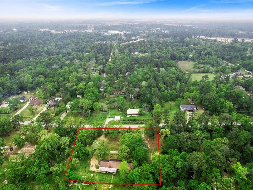 2940 Ave M Conroe, TX 77301 - Photo 2 of 6 an aerial view of residential houses with outdoor space and trees