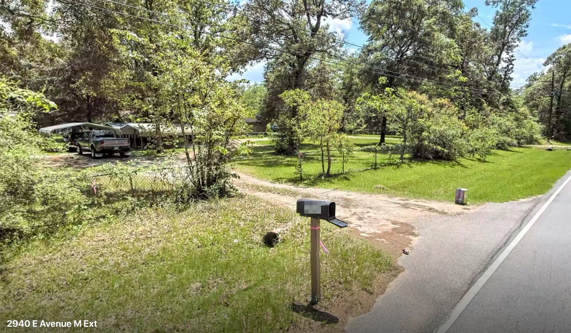 2940 Ave M Conroe, TX 77301 - Photo 3 of 6 a backyard of a house with a yard and outdoor seating