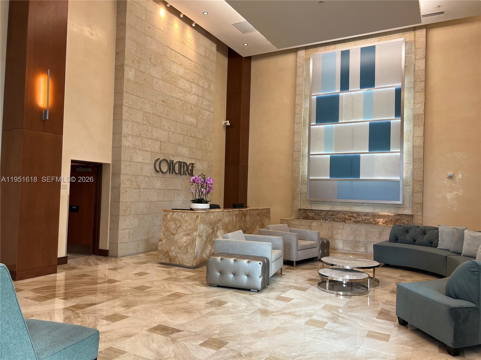 31 Southeast 5th Street, Unit 1409 Miami, FL 33131 - Photo 14 of 16 a living room with furniture and a window