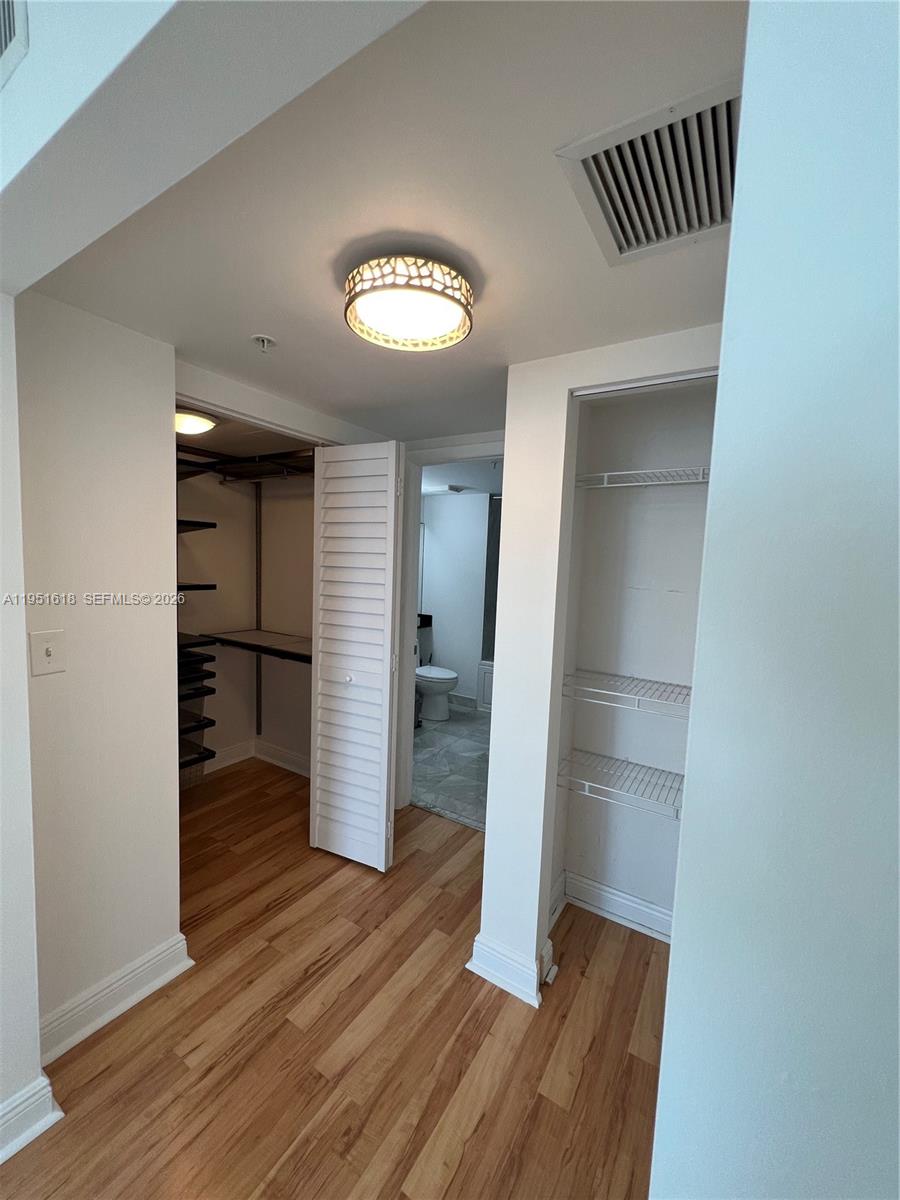 31 Southeast 5th Street, Unit 1409 Miami, FL 33131 - Photo 7 of 16 wooden floor in an empty room