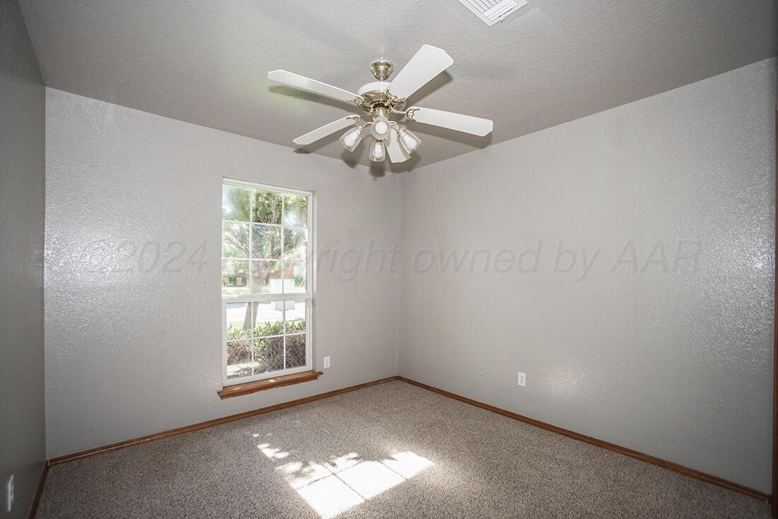 7909 Triumph Place Amarillo, TX 79119 - Photo 11 of 21 an empty room with windows and fan