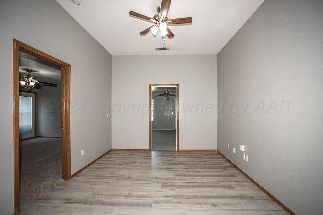 7909 Triumph Place Amarillo, TX 79119 - Photo 16 of 21 a view of an empty room with closet and a ceiling fan