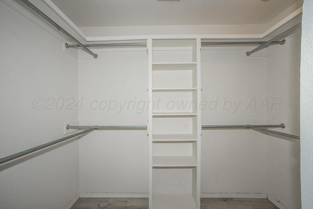 7909 Triumph Place Amarillo, TX 79119 - Photo 19 of 21 a view of walk in closet with empty racks