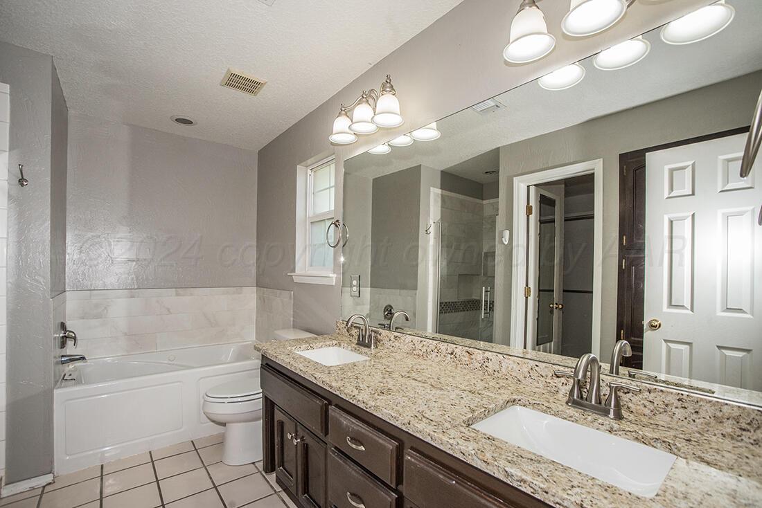7909 Triumph Place Amarillo, TX 79119 - Photo 20 of 21 a bathroom with a granite countertop double vanity sink mirror bathtub and toilet