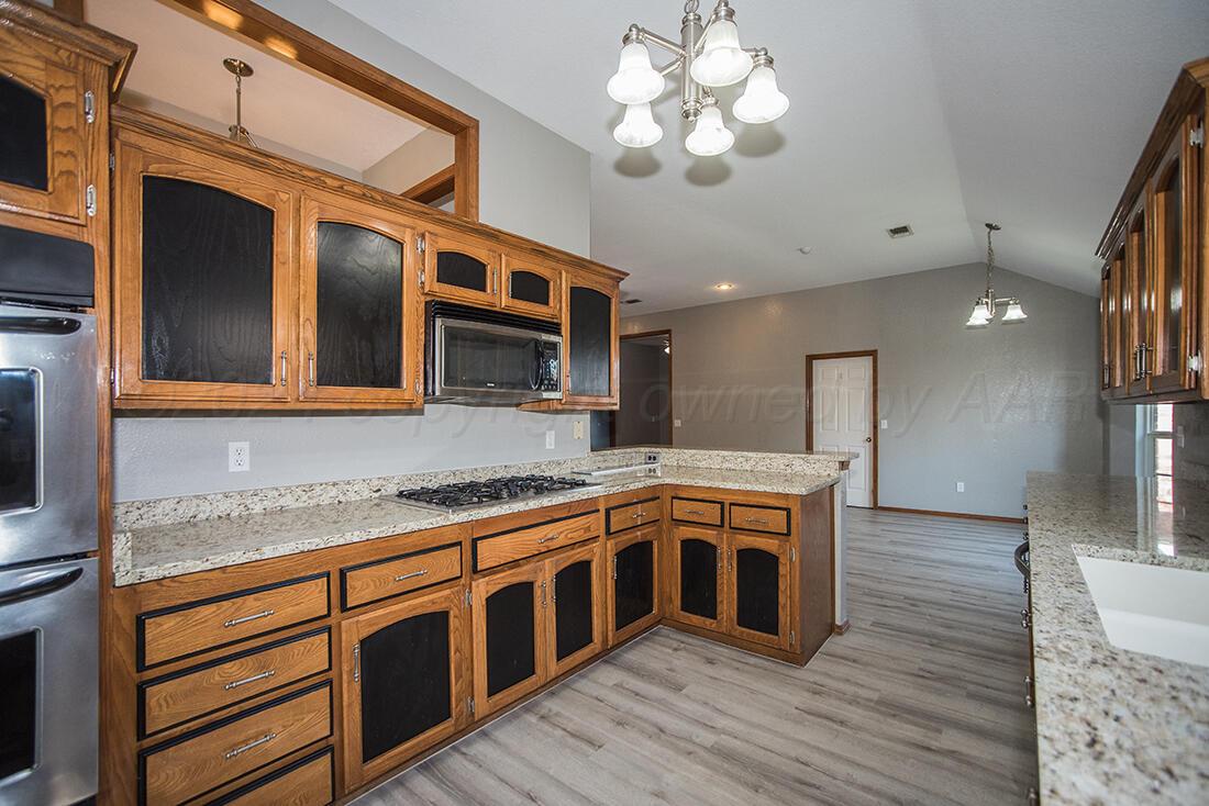 7909 Triumph Place Amarillo, TX 79119 - Photo 5 of 21 a kitchen with stainless steel appliances granite countertop a stove and a sink